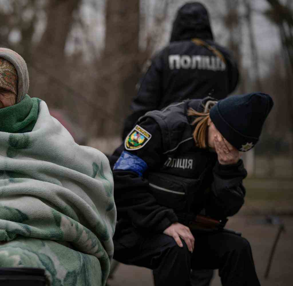 A Ukrainian policewoman is overcome with emotion after comforting people evacuated from the Kiev suburb of Irpin