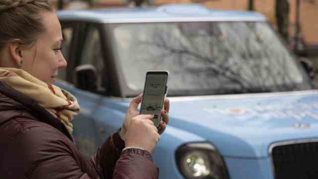 Local transport of the future: the blue taxi is ordered using a smartphone app.