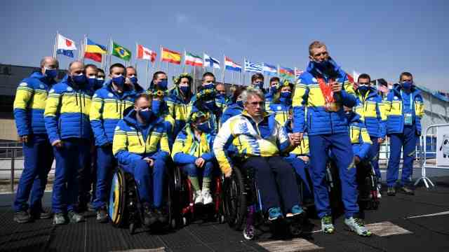 Ukraine at the Paralympics: hand in hand: Ukraine's committee chief Valery Sushkevich (left) and biathlete Grigory Vovchinsky in front of the Ukrainian team.