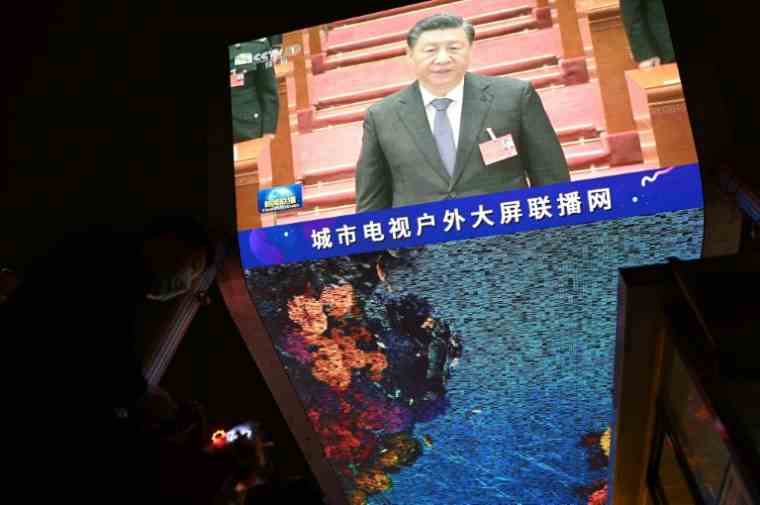 Chinese President Xi Jinping on a video screen in Beijing on March 11, 2022 (AFP/NOEL CELIS)