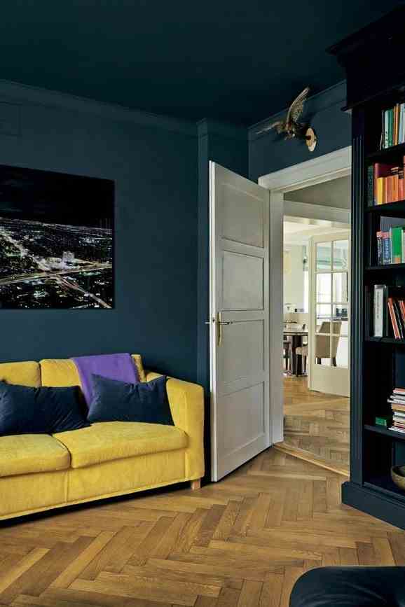 A Small Living Room In Dark Blue 