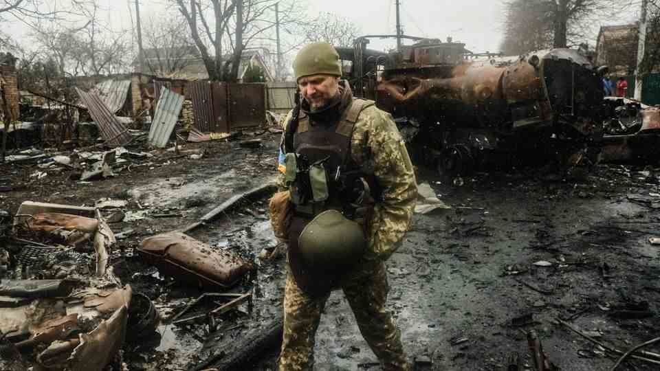 Ukrainian soldier inspects Bucha