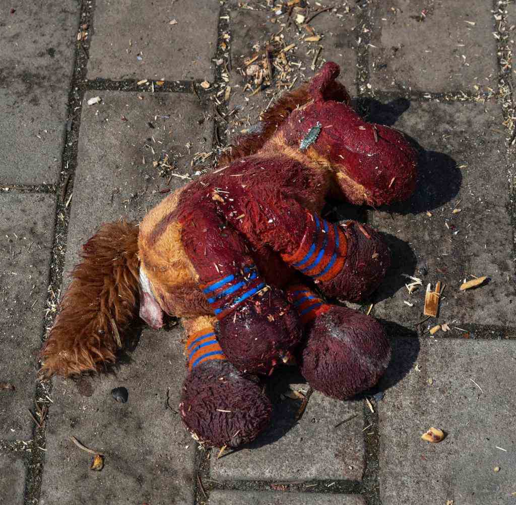 A blood-smeared stuffed animal horse at the train station