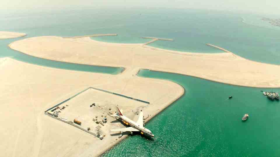 Eight months on land in Bahrain, the decommissioned Boeing 747-200 was prepared to dive to become part of the world's largest underwater theme park.
