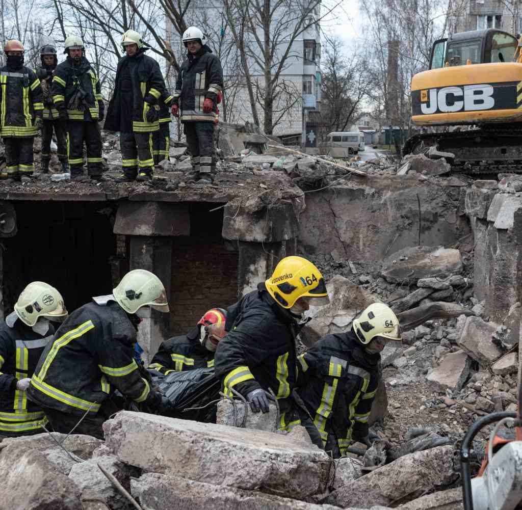 Rescue workers recover buried bodies from a block of flats in Borodyanka