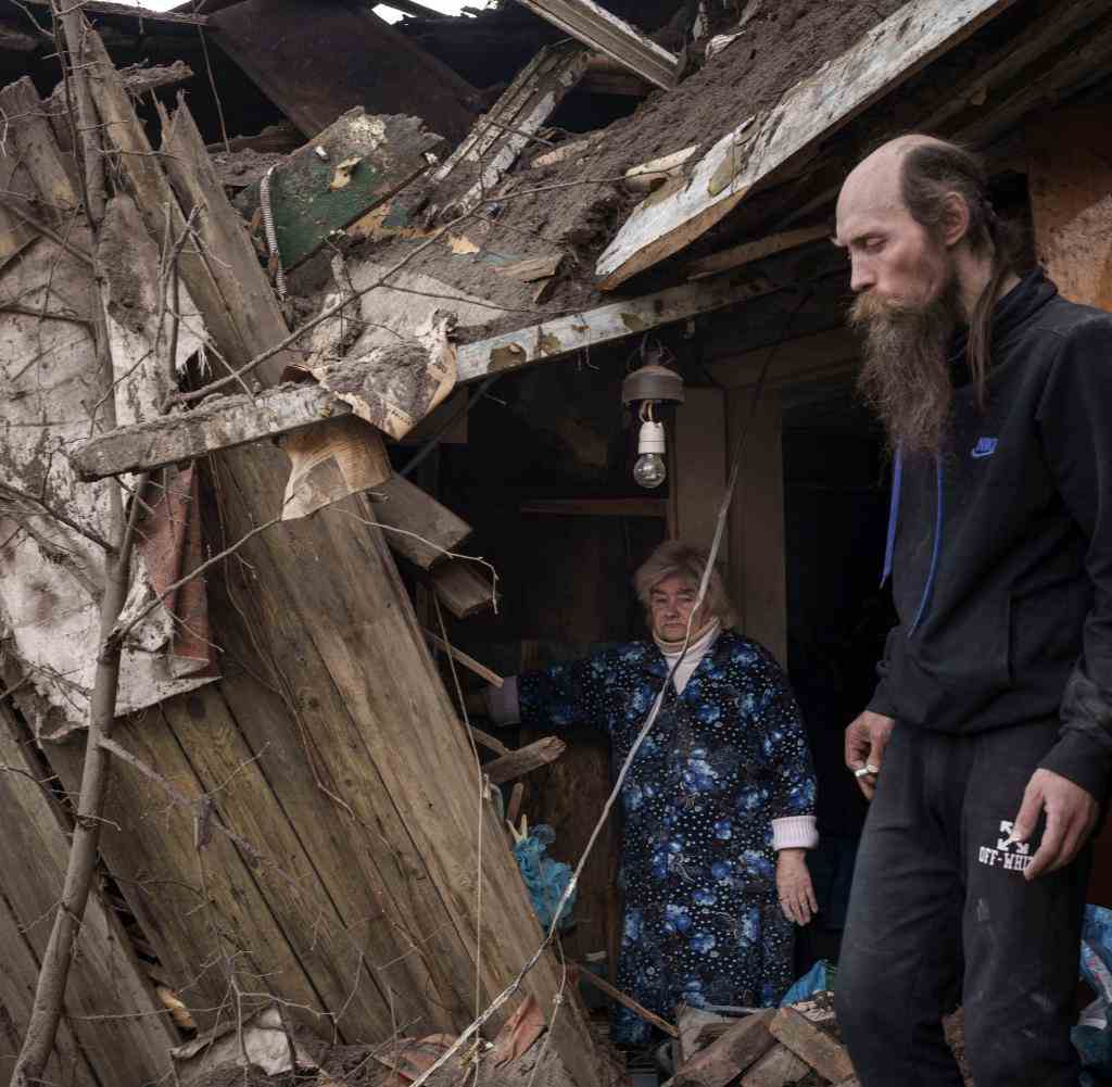 Kharkiv residents in their destroyed house
