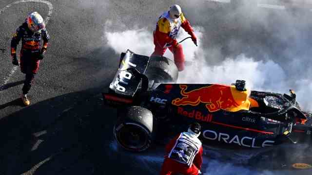 Formula 1: Closing time early: Max Verstappen (left) watches marshals extinguish the fire on your Red Bull.
