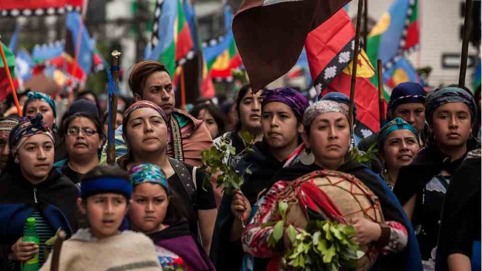 Members of a Mapuche community at a funeral march