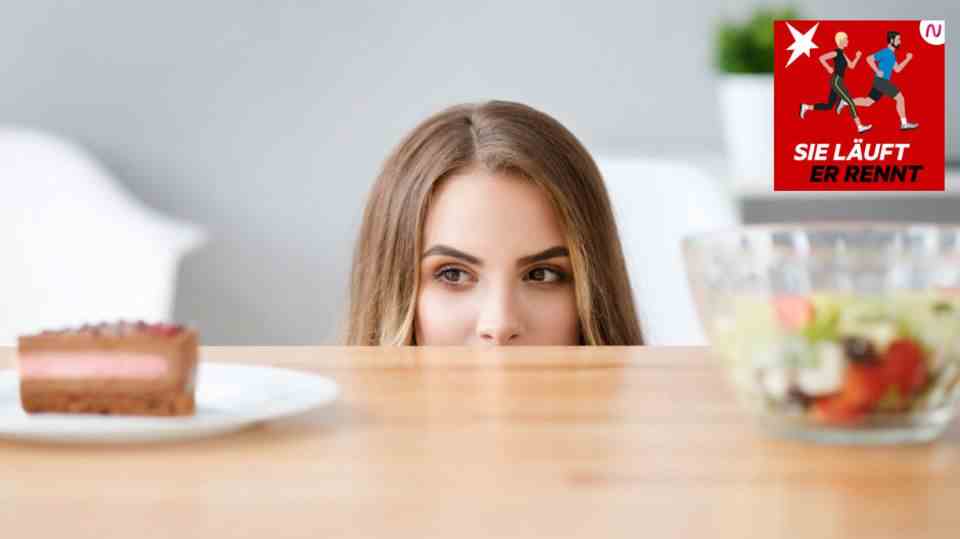 A woman looks over the edge of a table at salad and cake