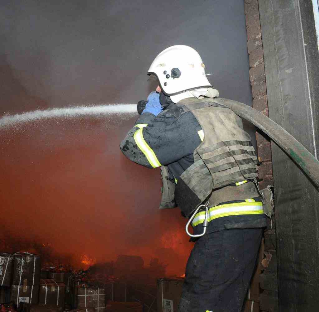 A firefighter puts out a fire that broke out after Russian military shelling in Kharkiv