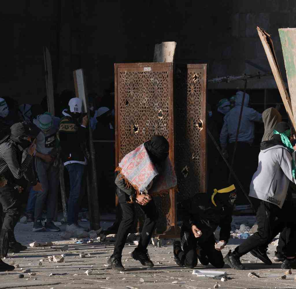 Palestinians threw stones while Israeli police fired tear gas and stun grenades