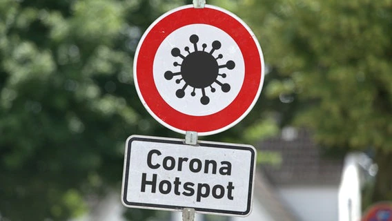 Traffic sign with a corona virus pictogram and an additional sign with the inscription: "Corona hotspot".  © picture alliance / SULUPRESS.DE |  Torsten Sukrow/SULUPRESS.DE 