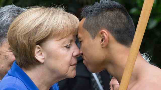 Welcoming rituals: Angela Merkel kissing a Maori representative in 2014.