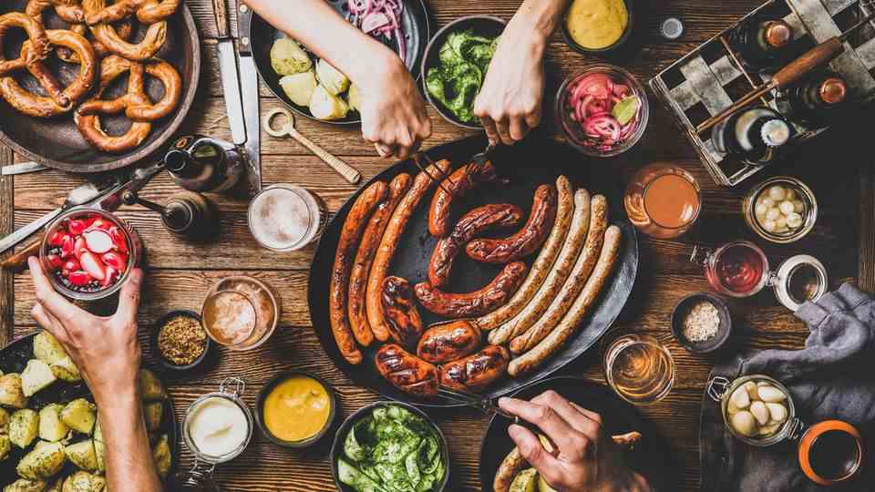 A richly laid table with sausages and pretzels