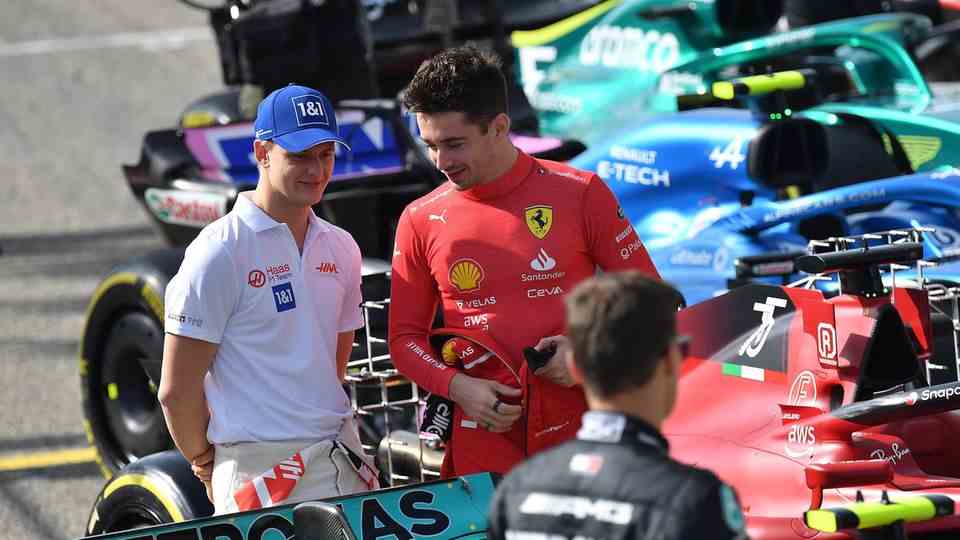 Drivers Mick Schumacher and Charles Leclerc after a race