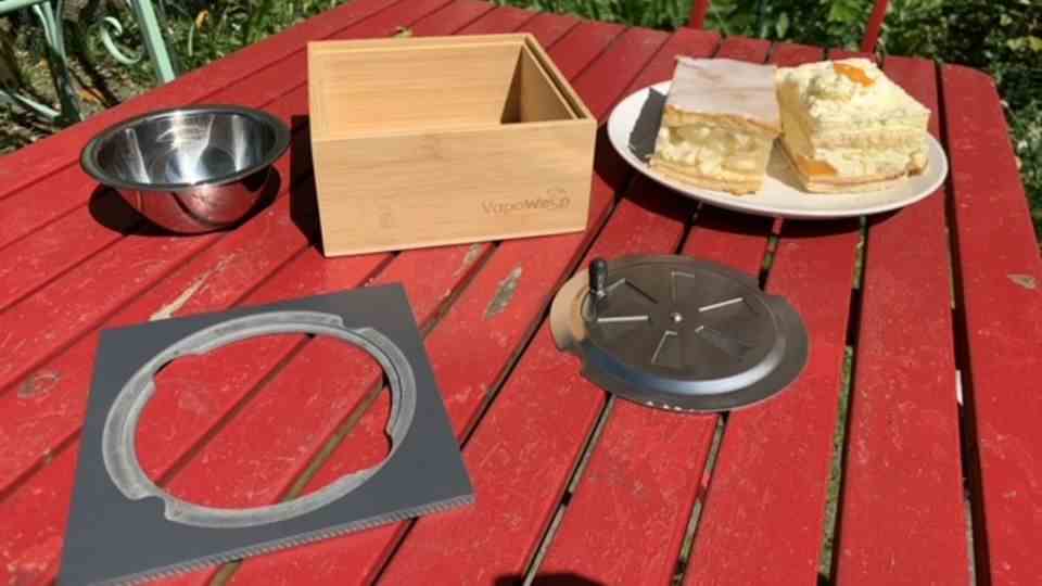 Wooden box, bowl, frame and lid stand next to the wasp bait.