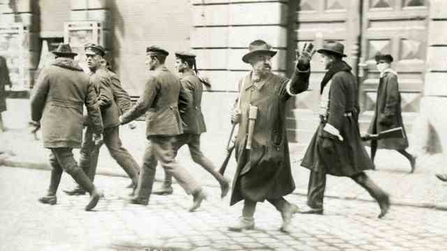 History: In May 1919, an armed vigilante led away captured Red Guards in Munich.