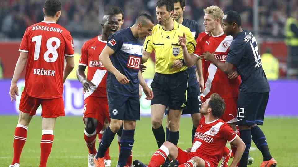 In May 2012, Hertha BSC Berlin meets Fortuna Düsseldorf.  It develops into what is probably the most legendary relegation duel in recent Bundesliga history.  Hertha lost the first leg in the Olympic Stadium 1-2.  In the second leg, Hertha's Änis Ben-Hatira (center) sees the yellow-red card.