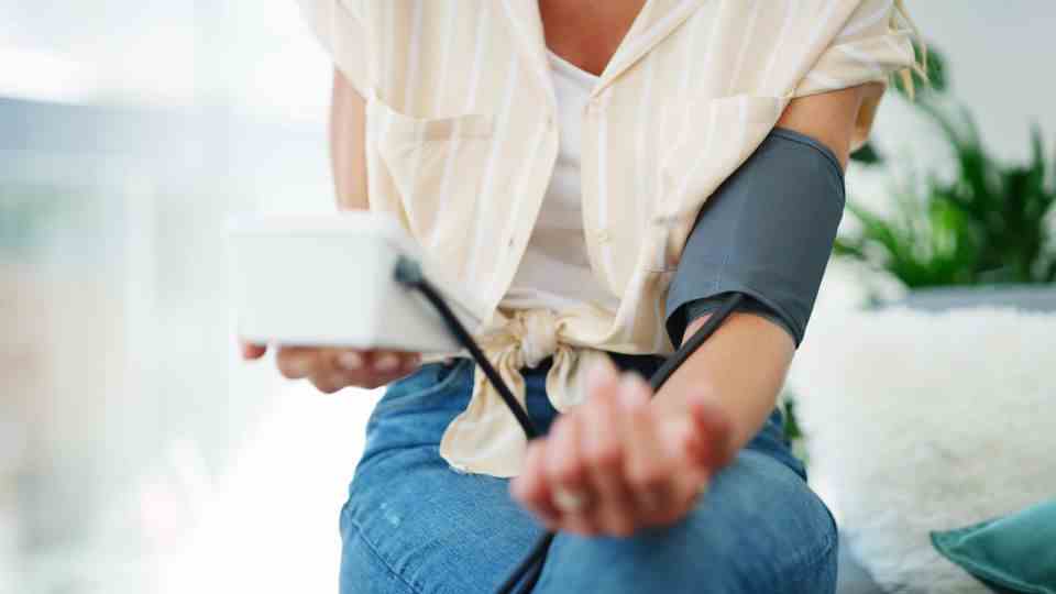 Woman measures her own blood pressure