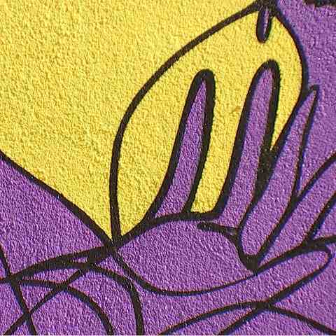 Close-up of a yellow and purple mural.