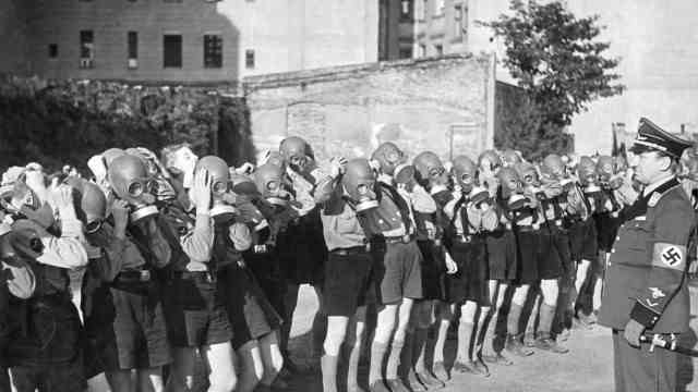 A summer with little oddities: Hitler Youth practice putting on gas masks in Berlin.