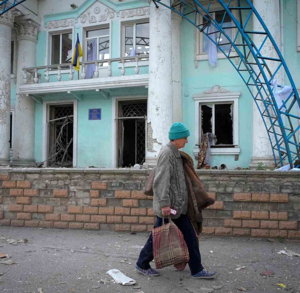Lysychansk: A woman walks near a building destroyed in a Russian airstrike in Lysychansk