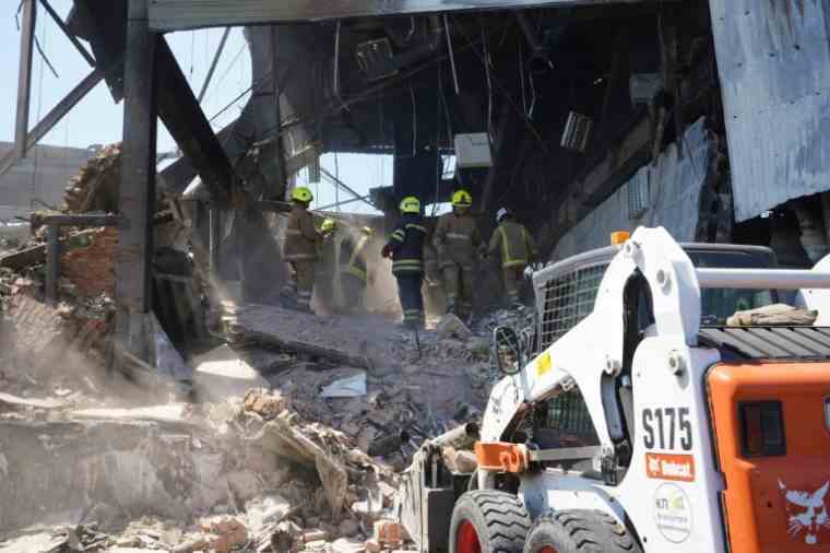 Workers in the rubble of a shopping mall hit by Russian missiles, June 29, 2022 in Kremenchuk, Ukraine (Ukrainian State Emergency Service Press Service/STR)