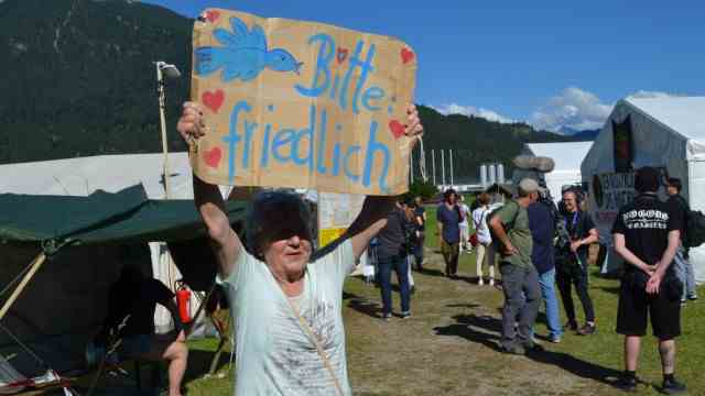 Protest camp for the G-7 summit: It's a colorful mix of people protesting against the G-7 summit in Elmau: Here an older woman holding a banner with the inscription "Peace please" holds high.