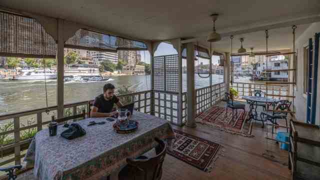 Urban planning in Cairo: Lovingly restored: The writer Omar Robert Hamilton on the houseboat that his mother bought in 2013 - it has since been cleared.