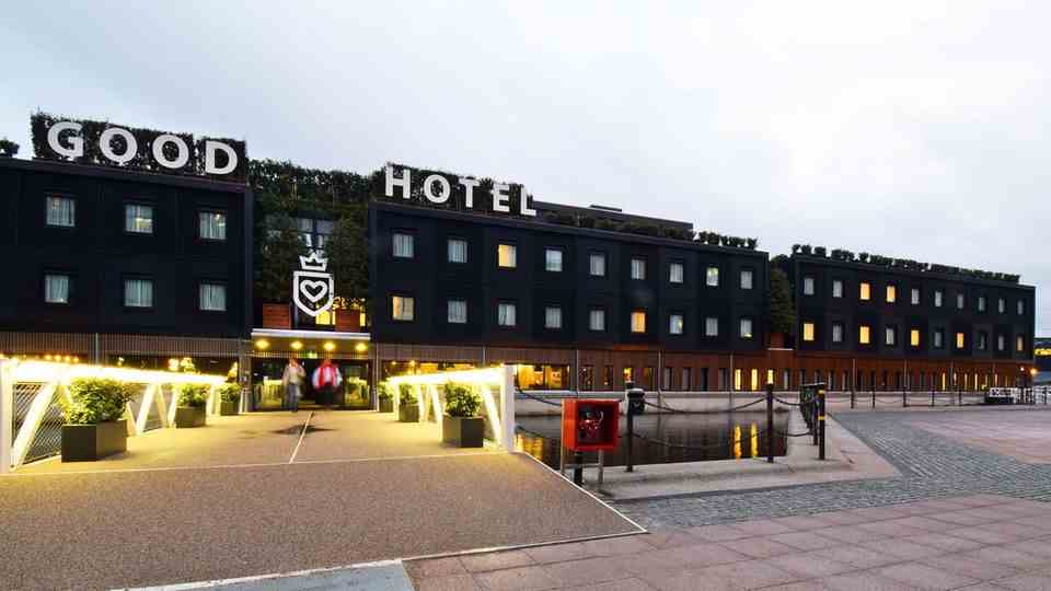 A huge black shoebox has moored on the shore of the Royal Victoria Docks: the Good Hotel London.