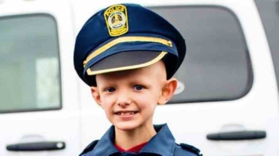 Little boy with cancer in police uniform