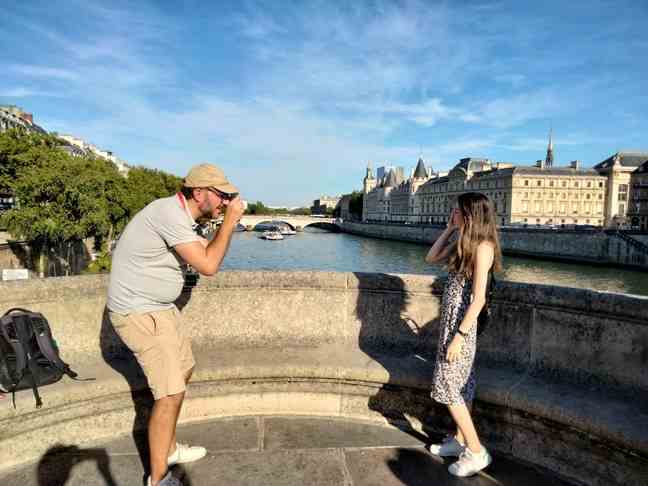 Guide François takes pictures of Emily in Paris fans