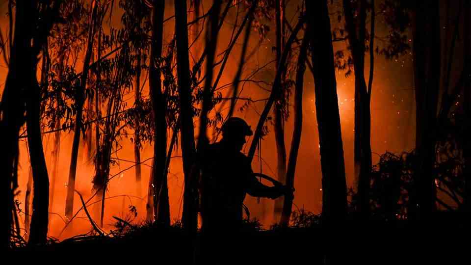 A firefighter fights the flames