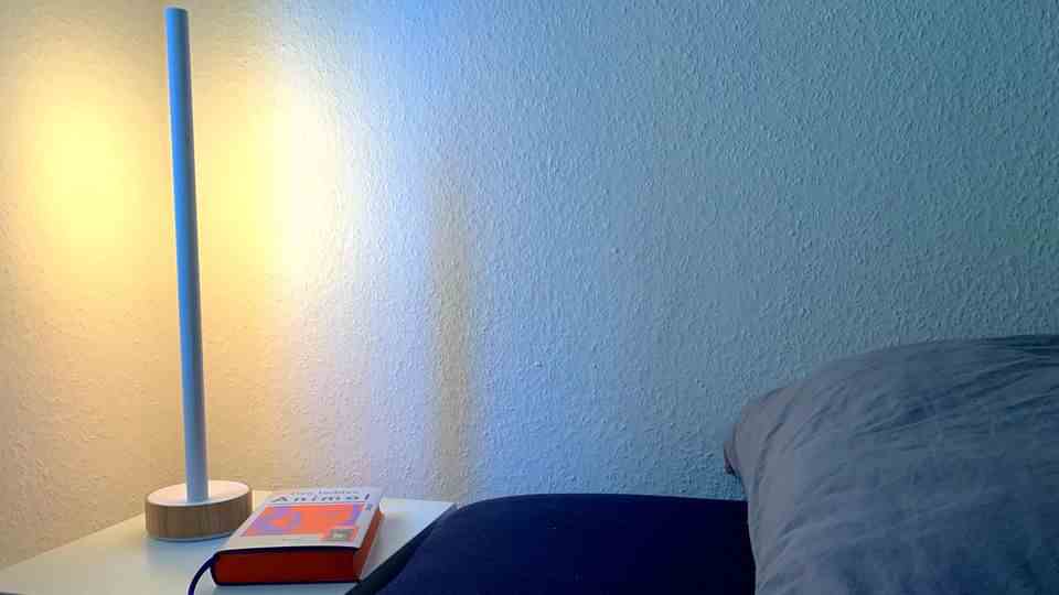 The Philips Hue Gradient Signe Oak as a bedside lamp.