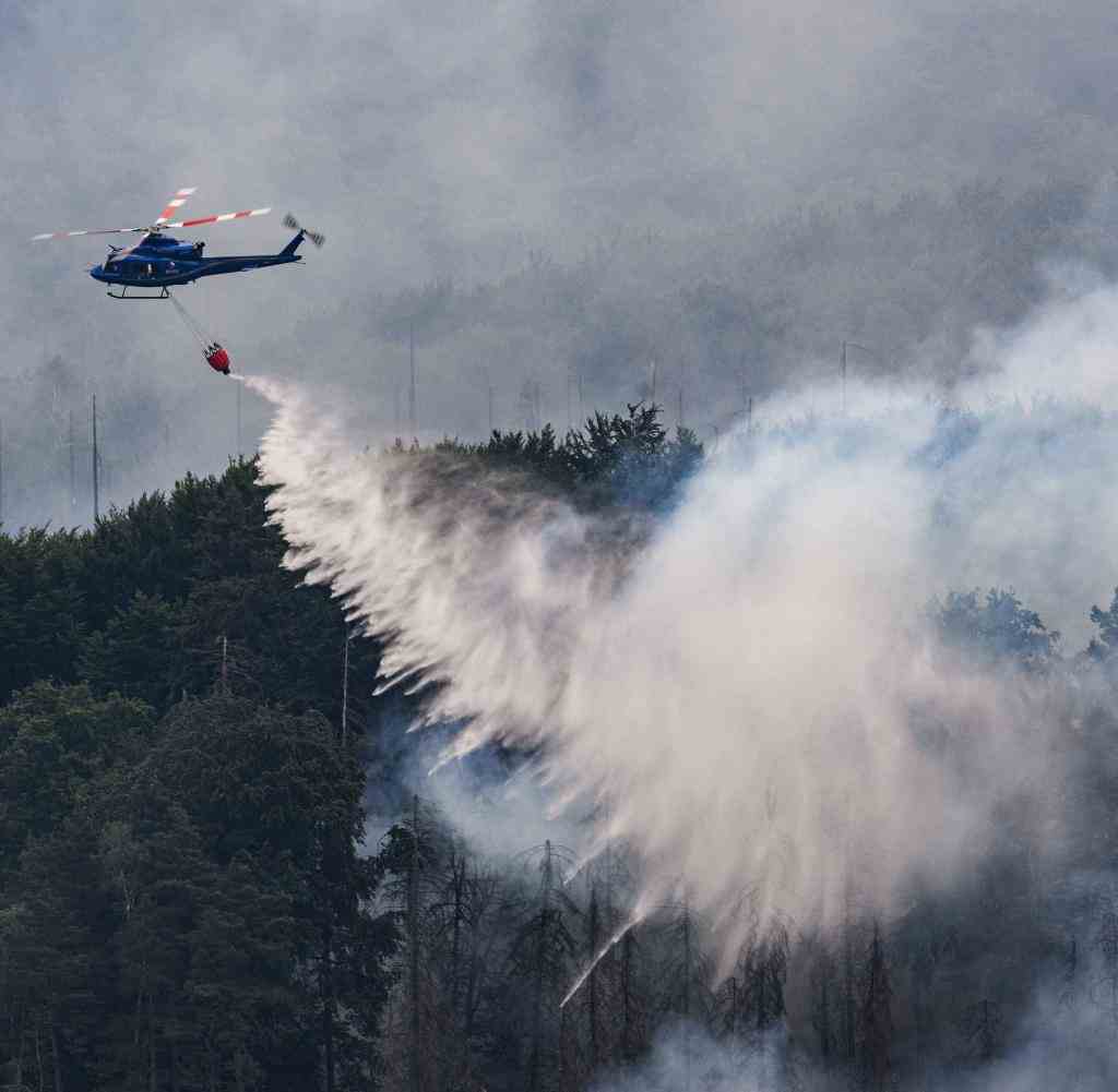 A firefighting helicopter is in action in Bohemian Switzerland in the Czech Republic on the border with Saxony
