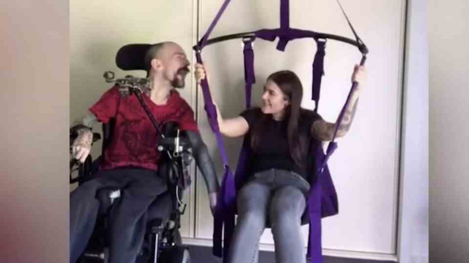 Olive Pearl in a sex swing next to Gavin Thorneeycroft in a wheelchair