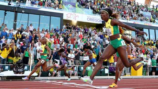 IAAF World Championships: Shelly-Ann Fraser-Pryce (left) crosses the finish line ahead of her compatriots Shericka Jackson (lane four) and Elaine Thompson-Herah.