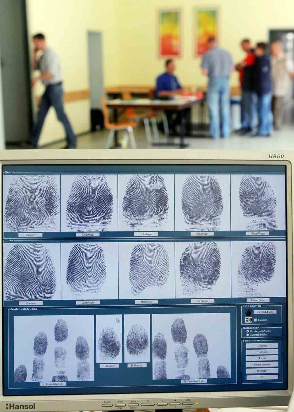 The fingerprints of a man can be seen on a computer screen in Bad Homburg