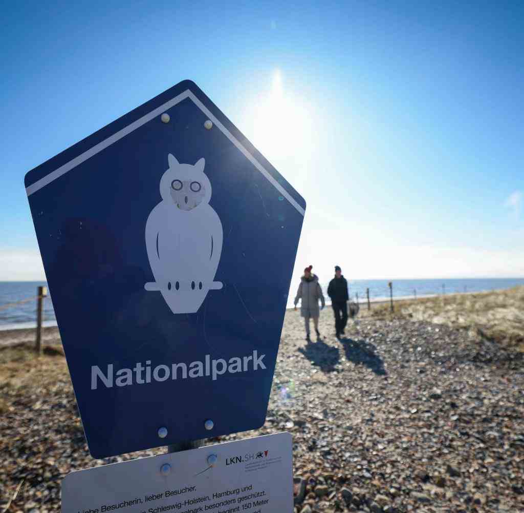 Ein Schild „Nationalpark“ steht am Strand neben dem Schutzgebiet Godelniederung an der Godelmündung bei Witsum auf der Nordseeinsel Föhr.