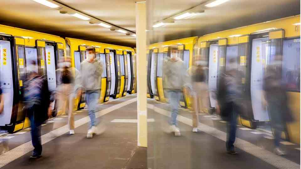 Passengers board an underground train in Berlin.