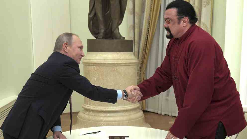 Putin and Seagal shake hands at Russian passport award ceremony