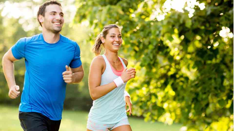 A man and a woman go jogging in the summer
