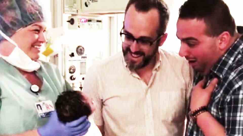 Gay couple see newborn daughter for the first time