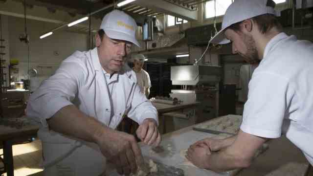 Bakeries in crisis: Martin Freundl (left), Freundl Junior (right) weigh amounts of dough for pretzel corners.