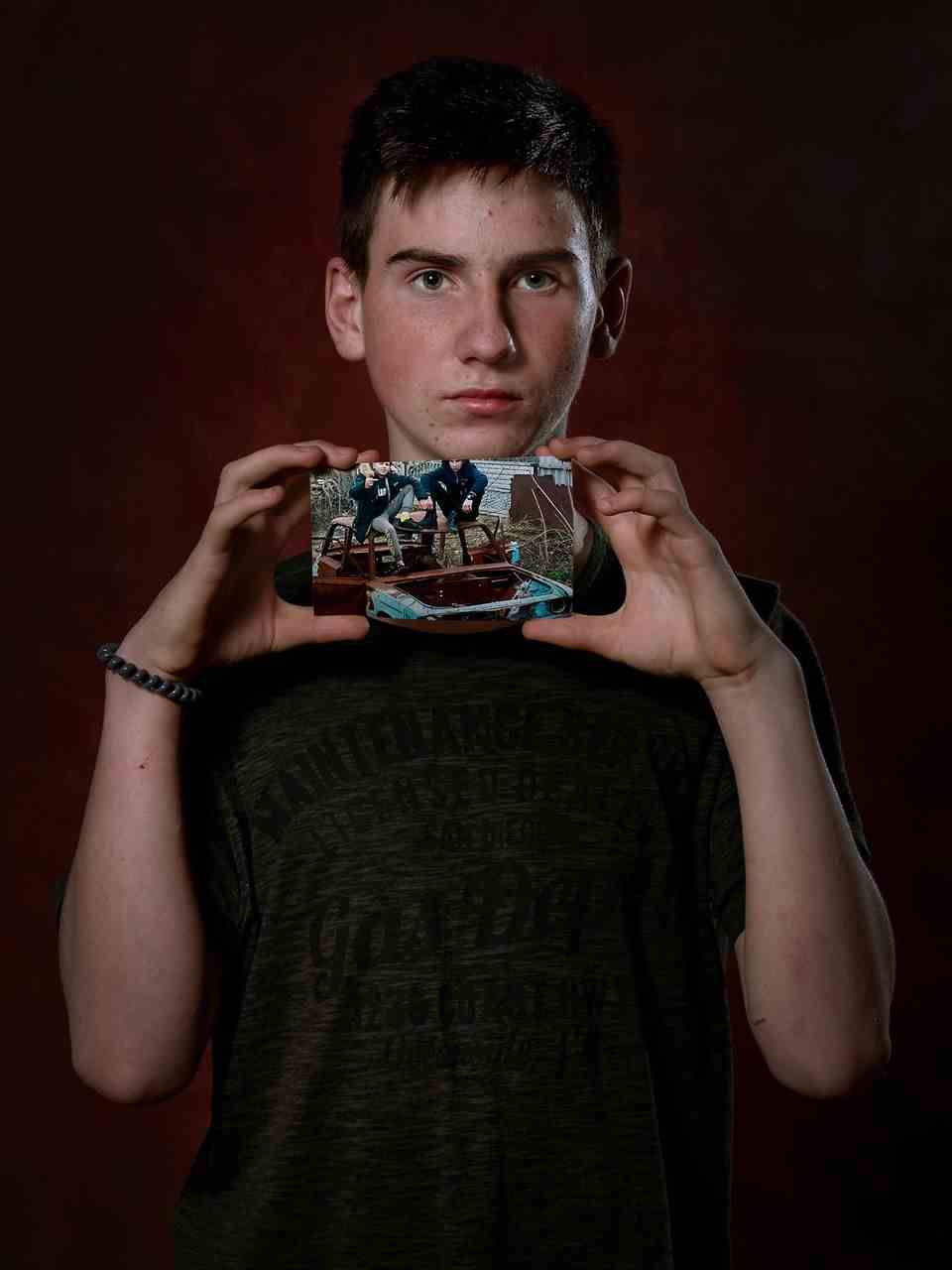 Maxim, from Ukraine, holds a photo print in his hand