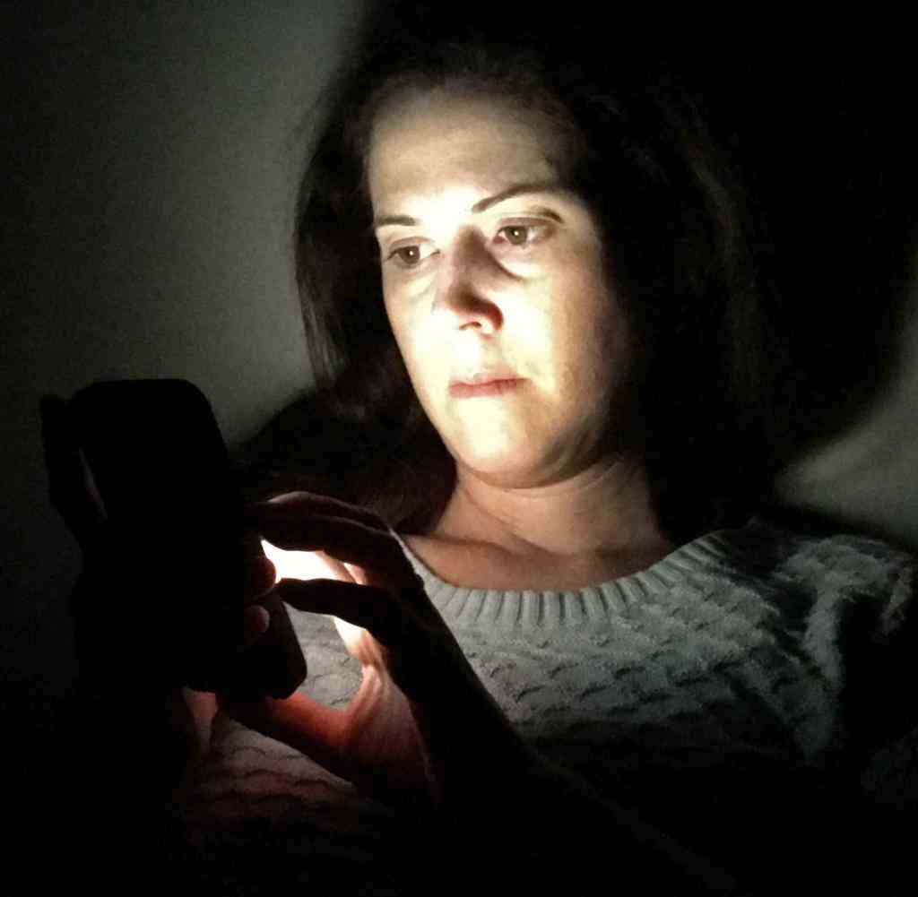 Adult Woman Using Smarphone in a Dark Night
