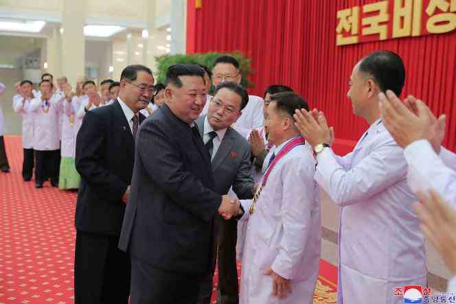 This August 10, 2022 photo, released by the Korean Central News Agency, shows North Korean leader Kim Jong-un greeting health department officials and scientists in Pyongyang.