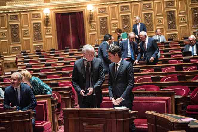 Bruno Le Maire, the Minister of the Economy, Finance and Industrial and Digital Sovereignty, speaks with the Minister Delegate in charge of Public Accounts, Gabriel Attal, during discussions on the amending finance bill, in the Senate in Paris, on August 1, 2022.