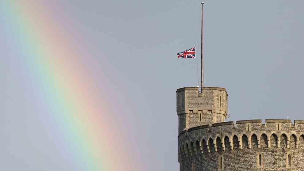 The flag at half-mast, along with the rainbow.  WHAT A PHOTO