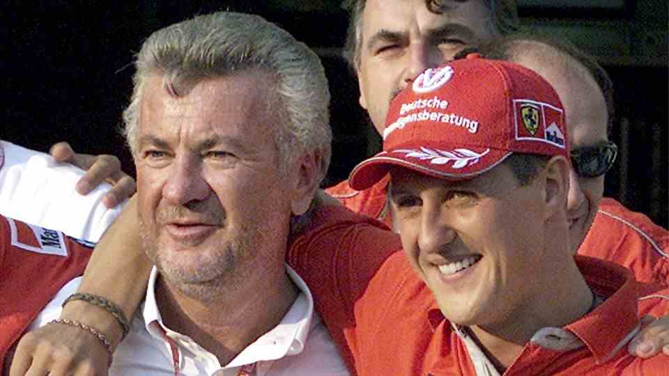 **ARCHIVE** Formula One driver Michael Schumacher driver of Ferrari hugs his manager Willi Weber August 19, 2001 in Budapest.  The Stuttgart public prosecutor's office has filed charges against Weber on suspicion of inciting the false testimony, as...